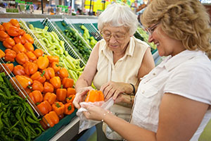 Woman with senior grocery shopping