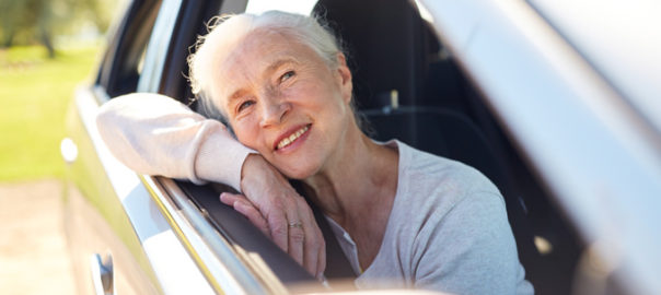 Senior woman as passenger in car