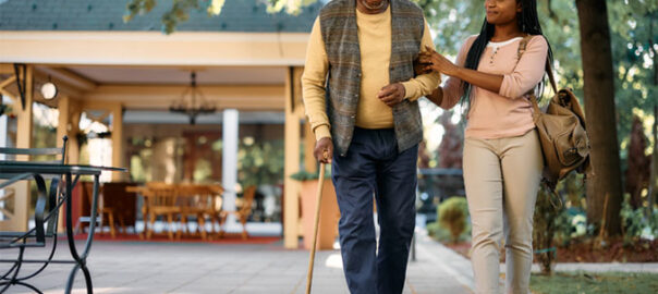 Senior man walking with young woman